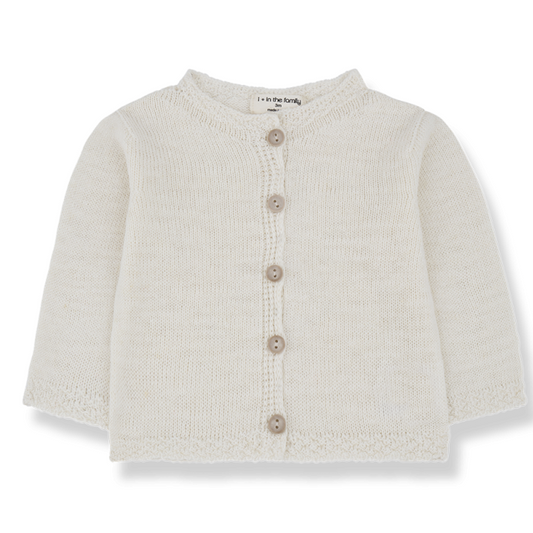 Soft cream-colored knitted baby cardigan with long sleeves and a round neckline. Features a button-up front with five wooden buttons and delicate knitted detailing along the edges. Made from cozy, lightweight fabric, perfect for layering. Brand label "1+ in the family" visible inside the collar.